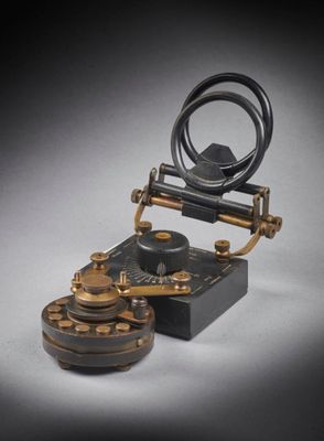 an old fashioned telephone is sitting on top of a table