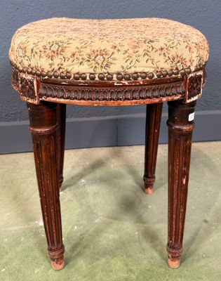 an antique wooden stool with a floral upholstered seat
