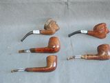 four different types of pipe smokings are lined up on a table