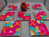 six pink plates with colorful flowers and leaves on them on a table