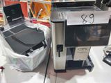 a coffee machine and a laptop sitting on a counter