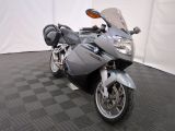 a motorcycle that is parked on a black and white checkered floor