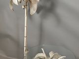a glass table with a lamp and a palm tree on it