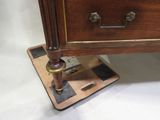 a wooden desk with a drawer on top of it