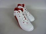 white and red sneakers with red laces on them on a white surface