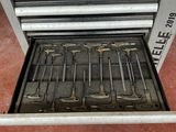 a tool box with tools inside of it on the floor