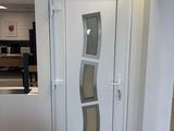 a white door with a glass panel on the side of it