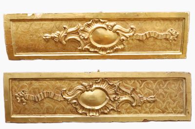 une paire de boîtes aux lettres en métal doré ornées de motifs élaborés
