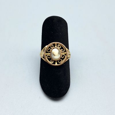 une image représentant une bague en or ornée d'une perle au centre