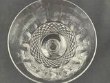 a glass bowl that has a spiral design on it