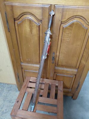 a wooden chair that has a bat on top of it