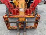 an image of a tractor with a fork attached to it ' s back