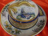 a plate with a picture of a woman sitting on it