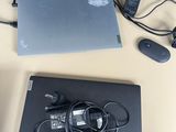 a laptop, mouse, and headphones on a table