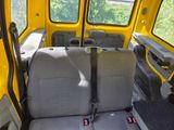 two seats in the back of a yellow vehicle