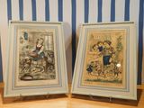 two framed pictures of a couple of people on a table