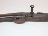 a close up of a gun on a table with a white background