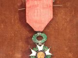 a red ribbon with a star on it on a brown surface