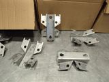 many pieces of metal on the floor next to a cardboard box