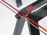a close up of a glass table with a red handle