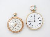 an image of a couple of clocks sitting on top of a white surface