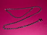 a close up of a chain on a pink surface