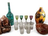 a group of glassware and a vase on a white surface