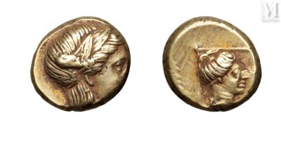 a close up of two gold coins with a bird on them