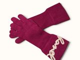 pink gloves with white writing on them sitting on top of a white surface