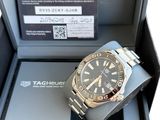 a watch in a box with a tag on it
