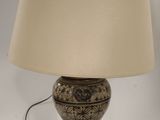 a lamp that is sitting on a table with a lamp shade on it