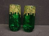 two green glass vases with gold designs on them