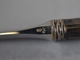 an old pen with a gold tip sitting on top of a table