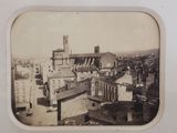 a black and white photo of a city with a clock tower