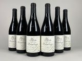 six bottles of red wine lined up in a row