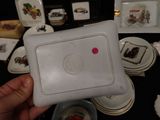 a person holding a white plate with a red dot on it