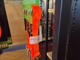 an orange leash hanging from a metal rack in a store