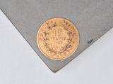an image of a gold coin on top of a piece of paper