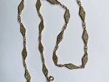 a gold chain with a heart charm on it