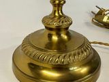 a gold lamp that is on a white table