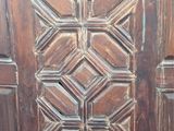 an old wooden door with a pattern on it