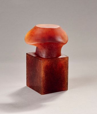 an image of a sculpture of a mushroom sitting on top of a wooden block