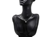 black mannequin bust with a star pendant on it ' s neck