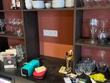 many glasses and plates on the shelves in the room