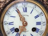 a blue and gold clock that is on a table