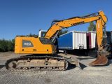 a yellow excavator that is sitting in the dirt