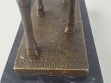 bronze statue of a man riding a horse on a marble base