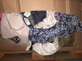 a cardboard box filled with clothes and a bag