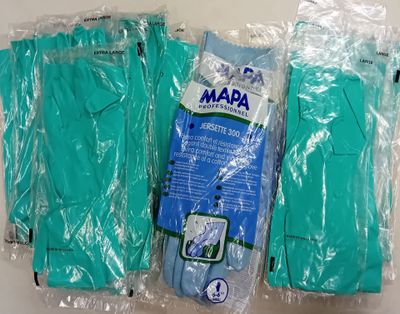 trois paires de gants verts sont emballées dans du plastique sur une surface blanche