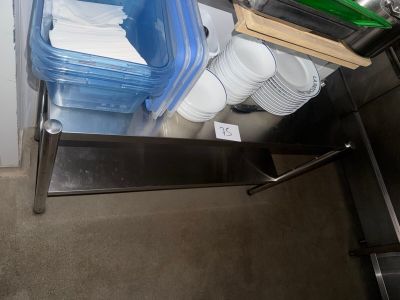 a stack of plastic containers on a metal shelf